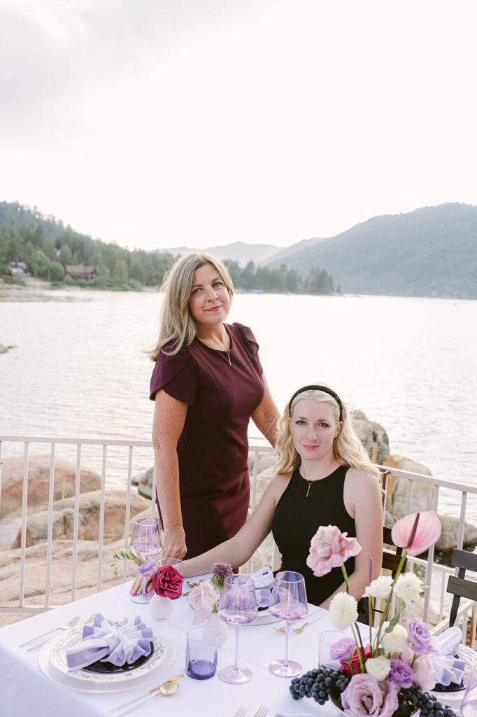 Wedding planner with a client at a lakeside wedding setup.
